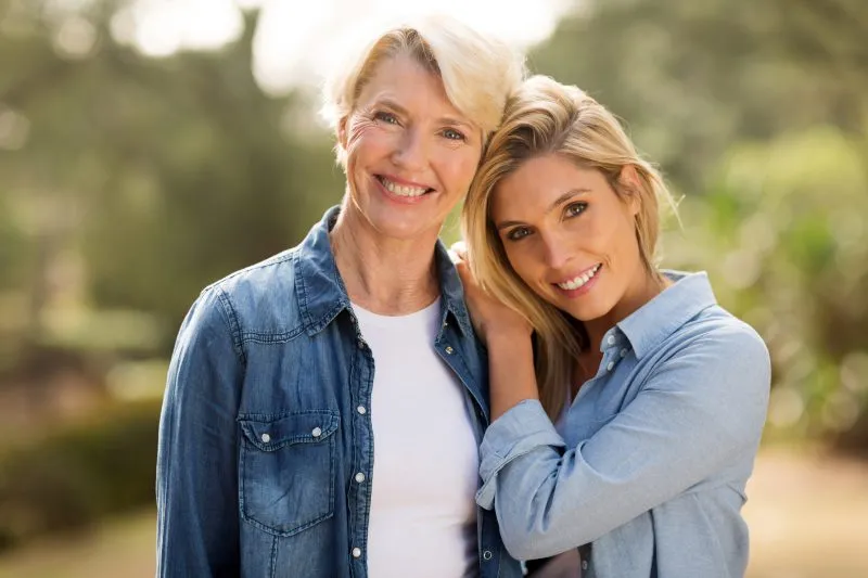 Mom and daughter smiling