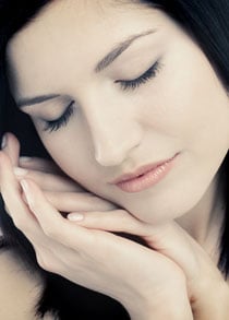 Woman with her head resting on her hands
