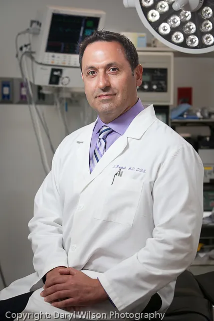 Photo of Dr. Merheb with dental equipment in the background